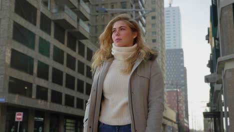 Confident-stylish-young-woman-poses-in-downtown-cityscape