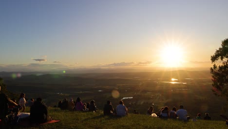 group of people enjoying sunset on a hill