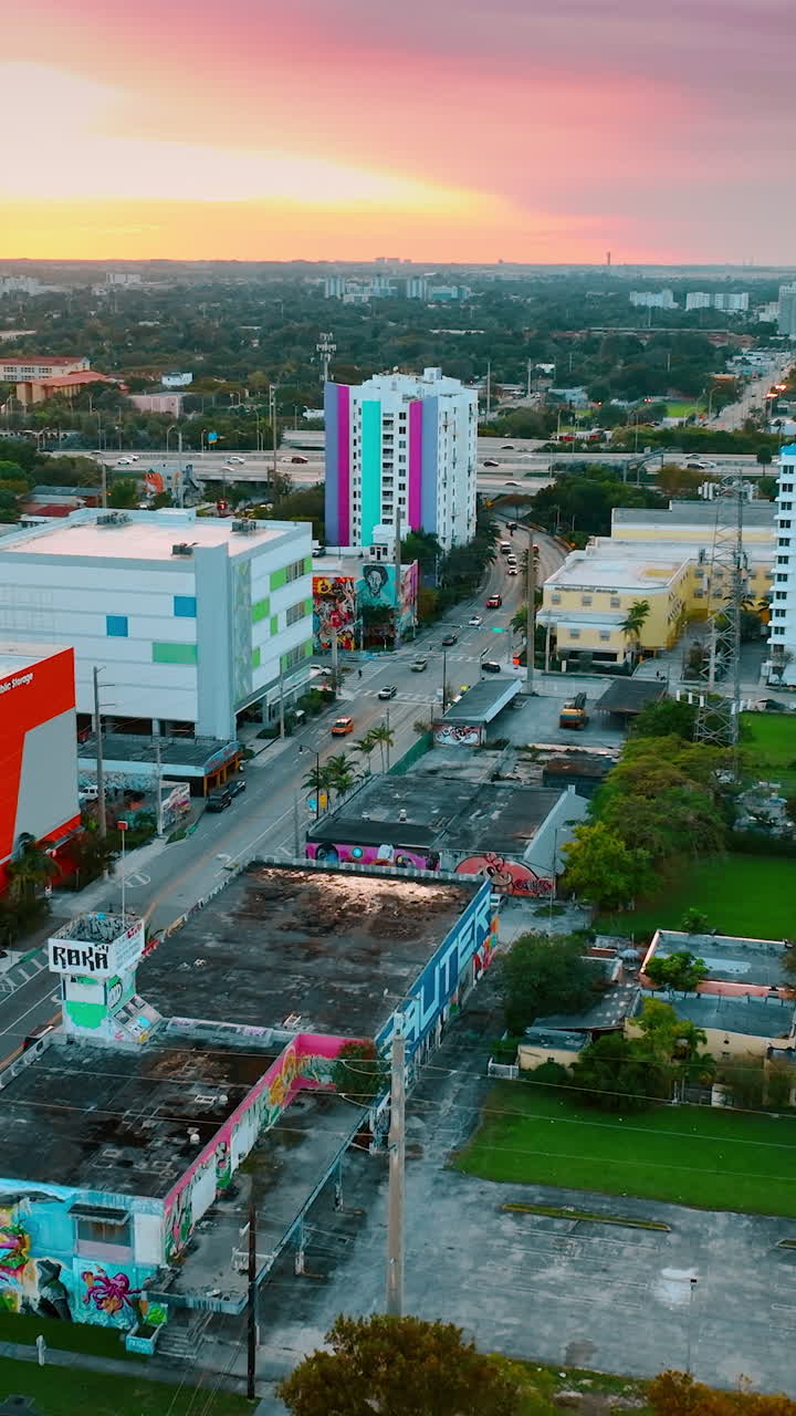 Colorful sky above the city panorama at sunset. Scenic view of Miami, Florida, USA from drone. Vertical video