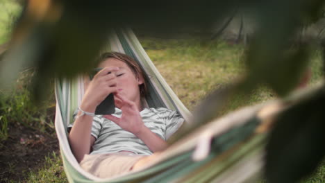 boy relaxing in a hammock on a sunny day