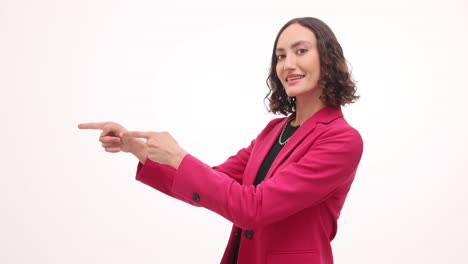 woman in pink blazer pointing and gesturing on white background