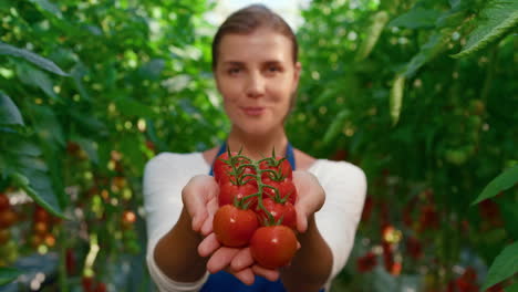 woman plantation worker showing vegetables in countryside farmland portrait