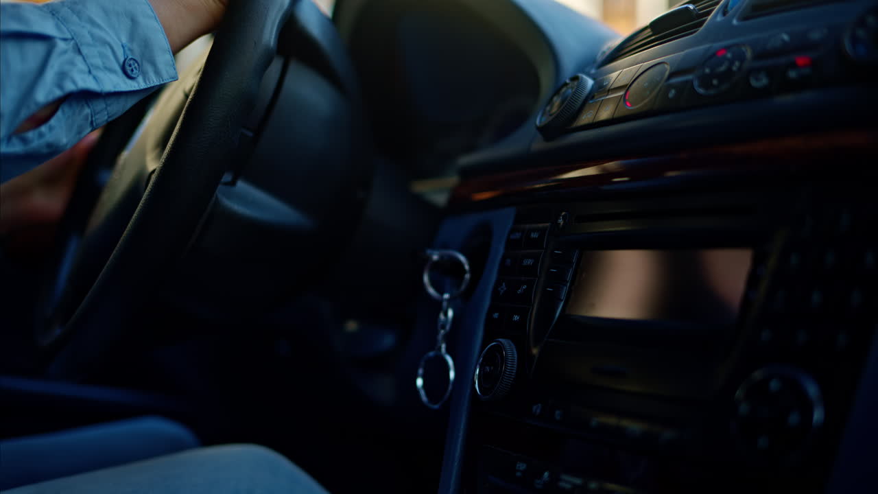 Person rotating the steering wheel while driving a car