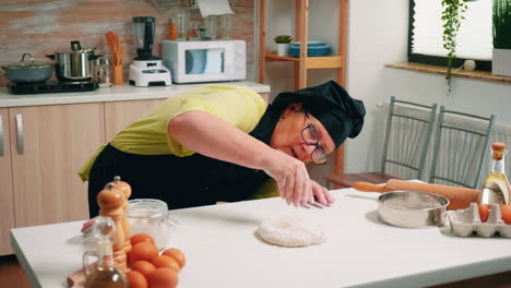 Floured-pizza-dough-on-wooden-table