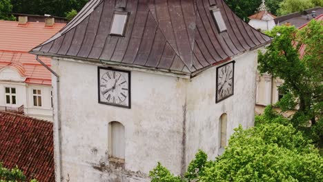 spiraling drone shot ascends church tower, ending with rooster-cross silhouette