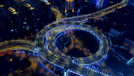 aerial view of roundabout of nanpu bridge, shanghai downtown, china. financial district and business centers in smart city in asia. top view of skyscraper and high-rise buildings at night.