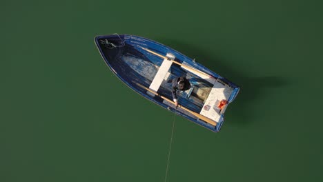 woman on the boat catches a fish on spinning in norway.