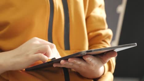 close up on the hand of caucasian woman pointing and touching the screen of tablet. technology social network and communication concept