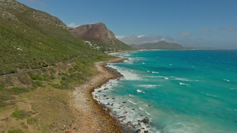 drone shot of the beautiful road between misty cliff and scarborough in western cape
