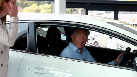 customers taking a look at a car