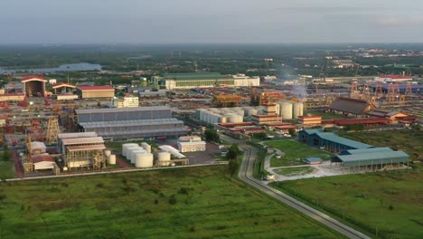 aerial slow zoom out shot capturing pgeo edible oil refinery food processing centre and sapura energy fabrication yard at lumut port industrial park, kampung acheh, sitiawan, perak, malaysia