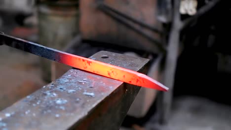 blacksmith forging the molten metal with hammer 4k