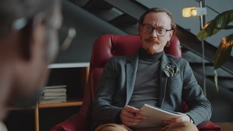 psychologist giving advice to patient on therapy session in the office