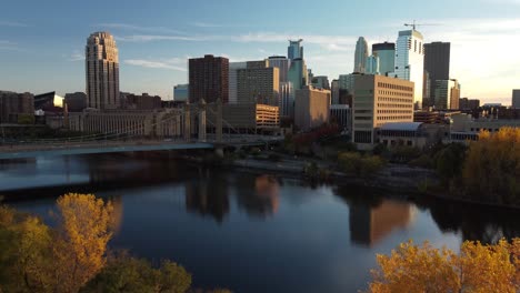 drone boom rise over downtown minneapolis from nicollet island during fall golden hour 4k