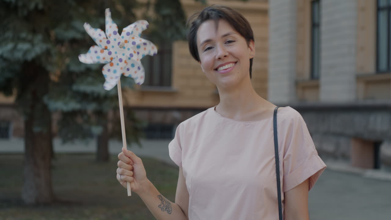 Woman holding a windmill toy