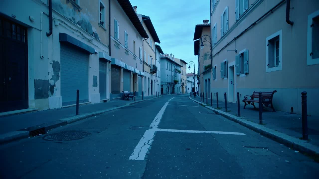 Playback starting camera translating slowly down narrow street, revealing road markings and benches