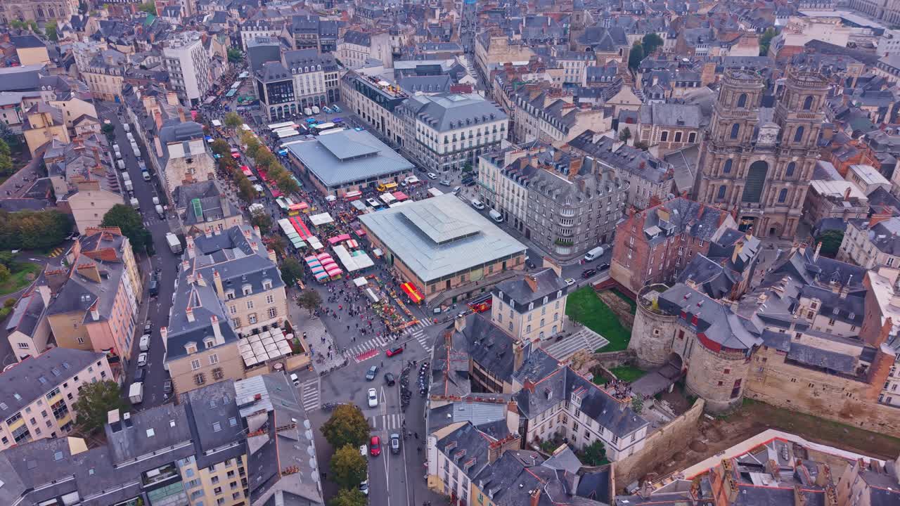 Marché des Lices, farmers market in Rennes, les portes Mordelaises and cityscape, France. Aerial drone, high angle