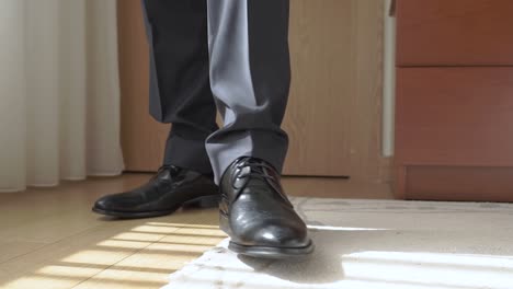 businessman dressed in suit standing by the window