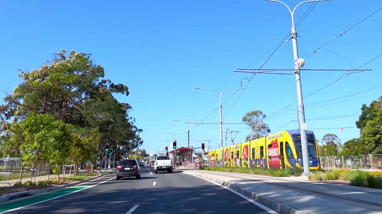 Vue subjective d'une conduite sur une route asphaltée à plusieurs voies sous un ciel bleu clair en Australie.