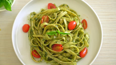 fettuccine spaghetti pasta with pesto sauce and tomatoes - vegan and vegetarian food style