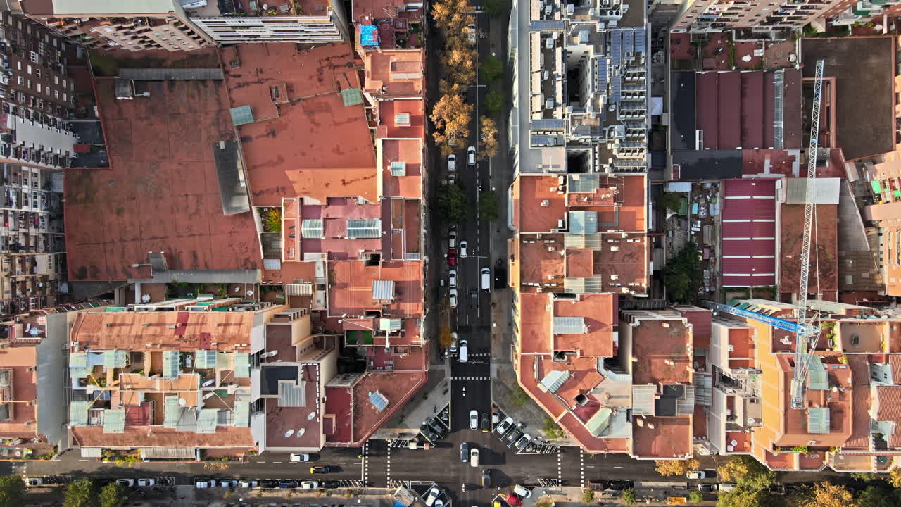 Aerial drone view of Barcelona, Spain. Blocks with multiple residential buildings, roads with cars
