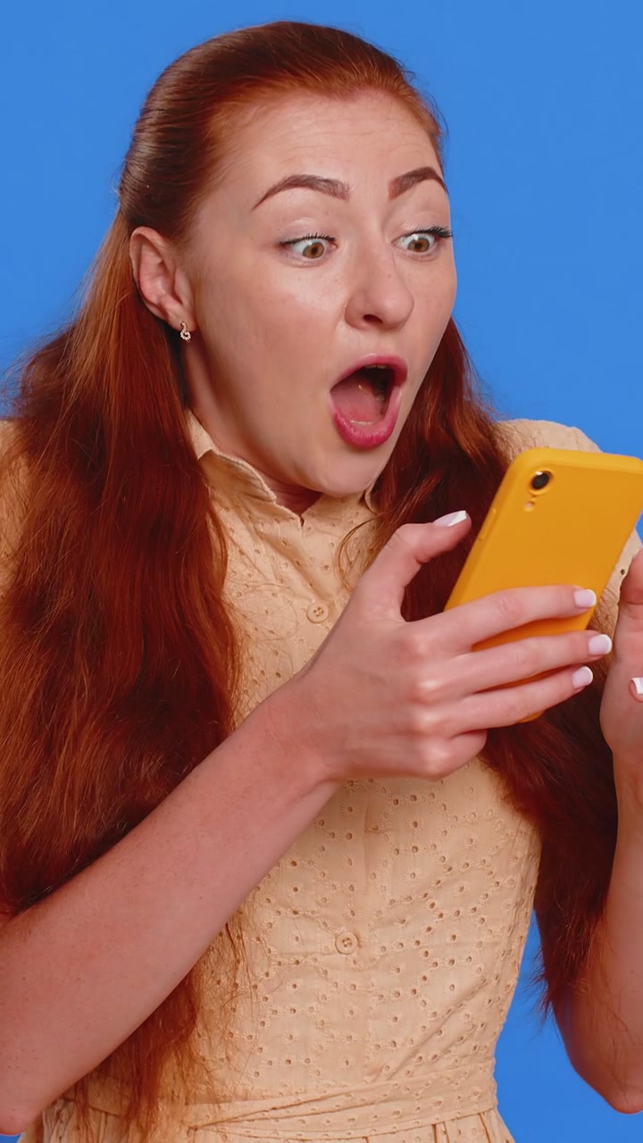 Glad begejstret vinderkvinde bruger smartphone, siger wow ja, fandt ud af stor sejr, gode nyheder, lotteri