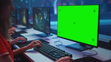 pro girl plays computer game plays rpg strategy on a championship. diverse esport team of pro gamers play in mock-up video game. stylish neon cyber games arena. side arc view
