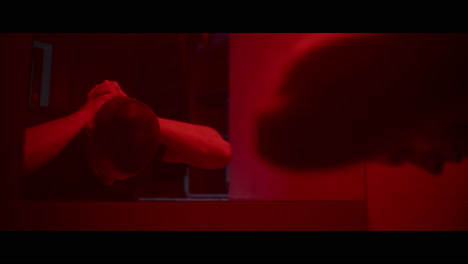 man in a red lit room