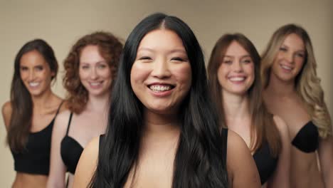 Group-of-cheerful-and-confident-women-in-underwear-looking-at-camera-and-standing-in-a-row.