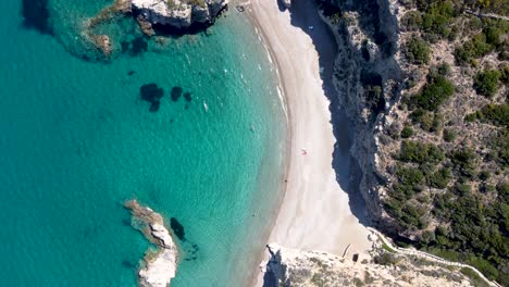 aerial wide top view of tourists enjoying the kaladi beach with crystal clear waters, greece