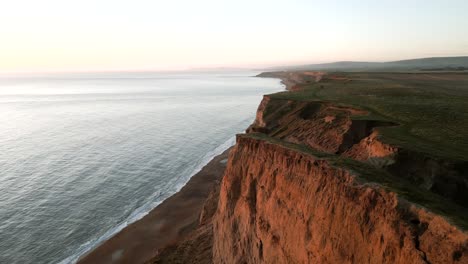 low drone shot of coastal cliff path