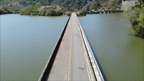aerial video,long cement bridge over reservoir in costa rica