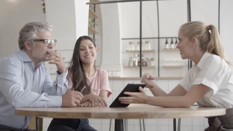 confident employees discussing project together in cafe