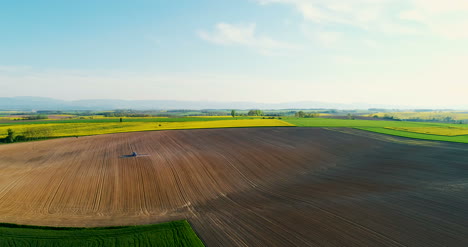 Aerial-Shoot-Of-Tractor-Working-On-Field-Agriculture-