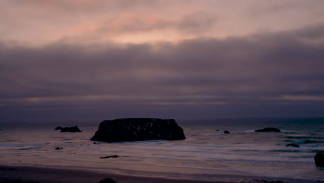 beautiful and moody cloud time-lapse over table rock in bandon, oregon coast, usa