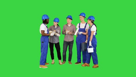 teamwork and people concept, group construction workers have a talk on a green screen, chroma key