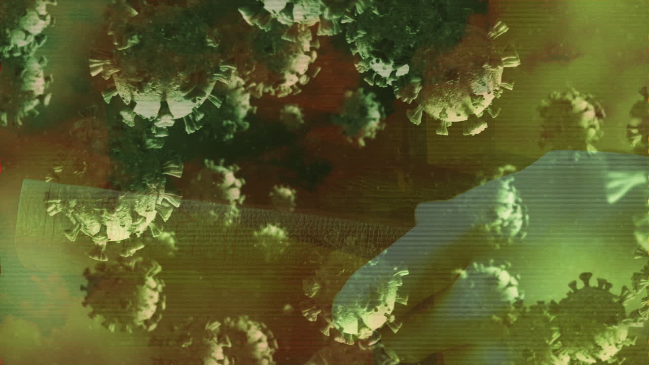 células de covid-19 moviéndose contra las manos sosteniendo el libro