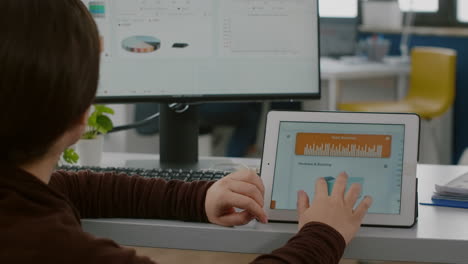 Handicapped-woman-entrepreneur-looking-at-computer-and-tablet