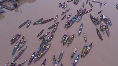 boats from floating food market on sungai martapura river in indonesia during cloudy day, aerial