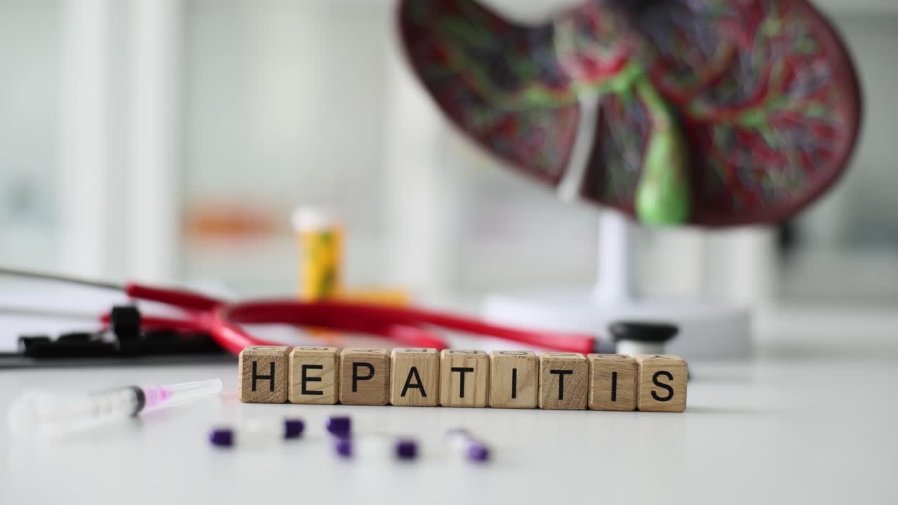Word hepatitis constructed of blocks against liver model