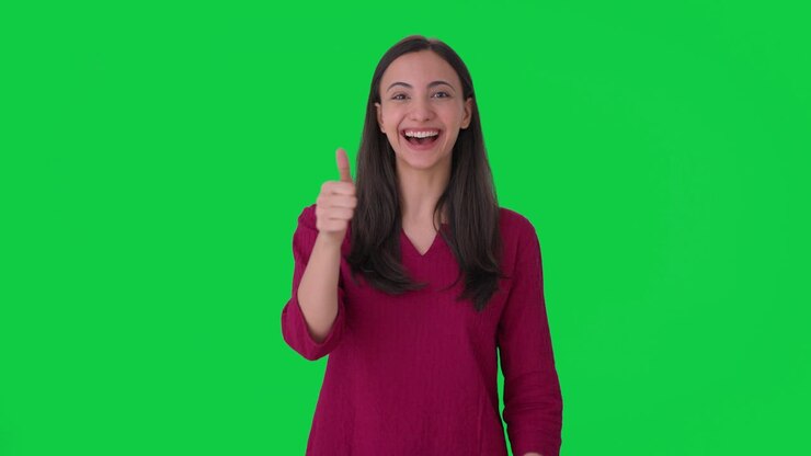 mujer india feliz mostrando los pulgares en la pantalla verde