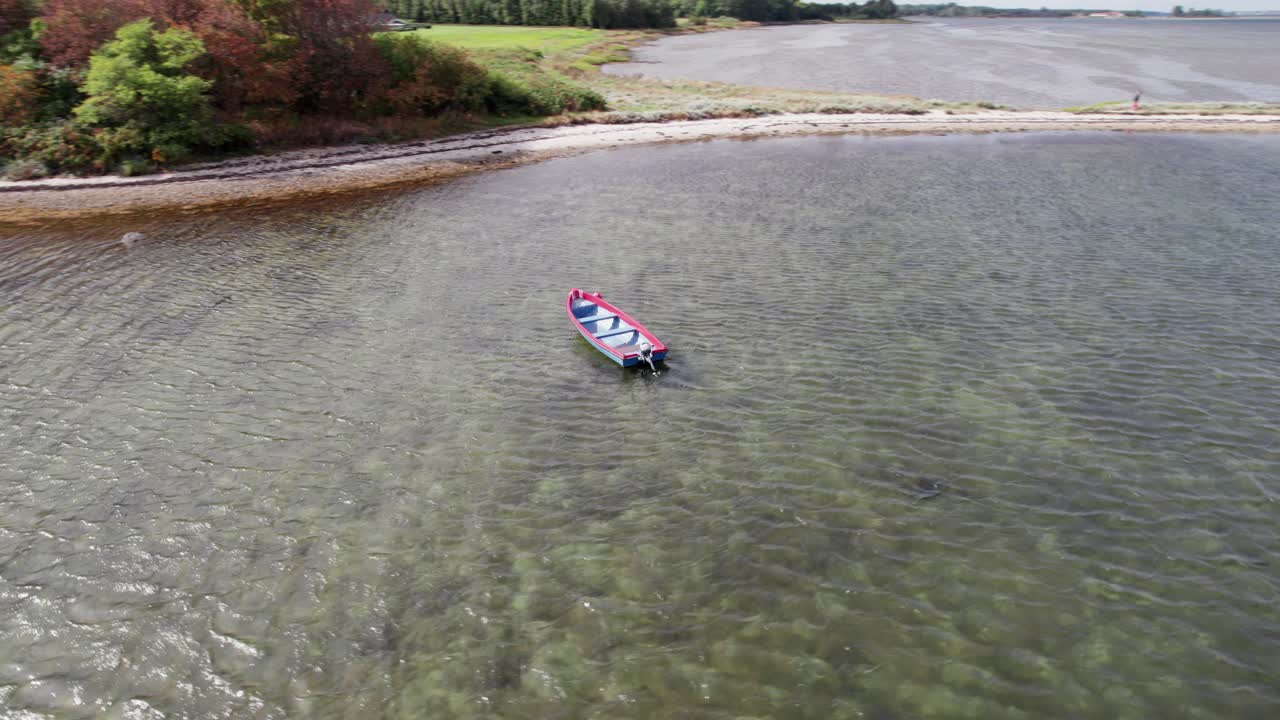 Drone Fly Around a Small Motorboat Lying at Anchor Off the Coast