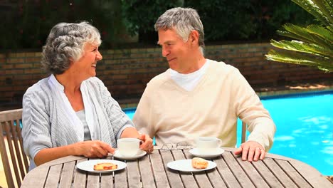 Retired-couple-having-coffee-outdoors