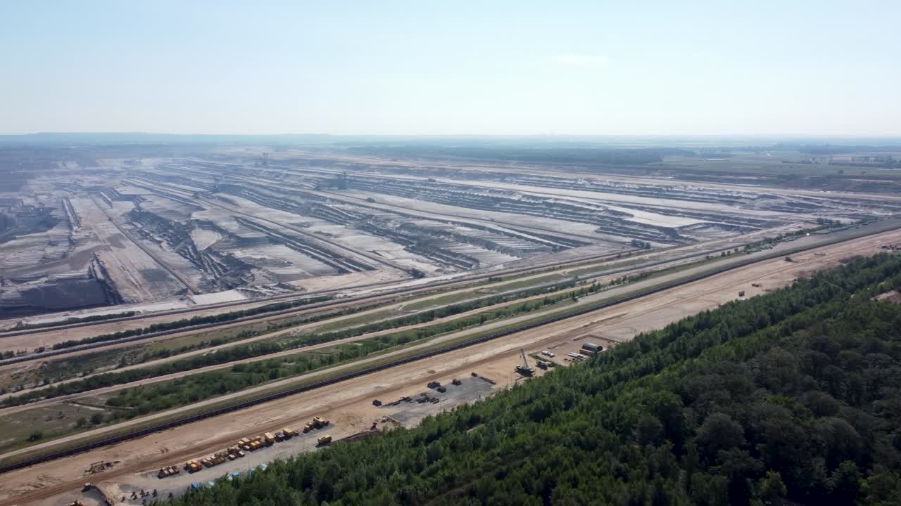 Opencast lignite mine in the Rhenish lignite mining area near Düren, Aerial flying from the forest
