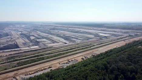 opencast lignite mine in the rhenish lignite mining area near düren, aerial flying from the forest