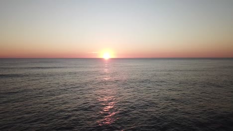 Imágenes-Aéreas-Estáticas-De-Una-Puesta-De-Sol-Distante-En-La-Playa-Con-Un-Océano-Tranquilo,-Costa-Rica