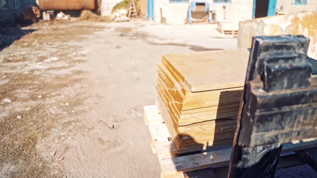 Reliable heavy loader. Close up view of forklift transporting cargo on road with marble