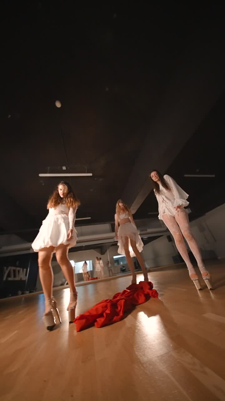 Three Women in White Performing a Contemporary Dance