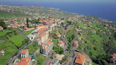 aerial moving over community on hillside of madeira portugal in midday