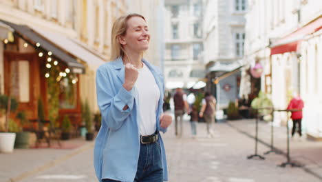 Excited-happy-woman-tourist-shouts-celebrating-success-winning-triumph-career-achievement-good-news